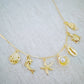 Golden Sea Charm Necklace – Shell, Dolphin & Starfish