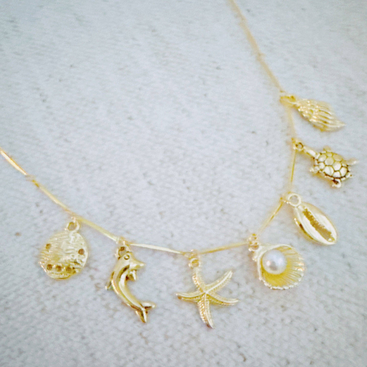 Golden Sea Charm Necklace – Shell, Dolphin & Starfish